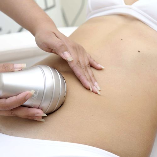 Woman receiving an ultrasonic cavitation treatment on her stomach at Derma Laser Spas in Sandy Springs, Atlanta.